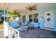 Inviting covered front porch with decorative ceiling fan and a welcoming seating area at 5801 Dartmouth N Ave, St Petersburg, FL 33710