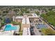 Aerial view of the complex featuring a large swimming pool, pond, tennis courts, and parking at 5820 N Church Ave # 148, Tampa, FL 33614