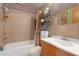 Cozy bathroom with a shower-tub combo, tile walls, and cloud-themed ceiling, offering a unique and functional space at 5820 N Church Ave # 148, Tampa, FL 33614