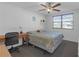 Bright bedroom featuring a window, ceiling fan, and neutral decor at 5820 N Church Ave # 148, Tampa, FL 33614