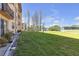 Well-maintained grounds beside the building with grassy area, shrubbery and tennis courts at 5820 N Church Ave # 148, Tampa, FL 33614
