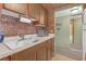 Kitchen area with a sink, countertop, and cabinets, showcasing a vintage-style interior with brick-like design at 5820 N Church Ave # 148, Tampa, FL 33614