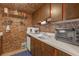 Cozy kitchen featuring wood cabinets, white countertops, and unique brick-like wall and ceiling design at 5820 N Church Ave # 148, Tampa, FL 33614