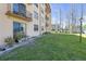 Ground floor patio with chairs, plants, and views of a grassy common area at 5820 N Church Ave # 148, Tampa, FL 33614