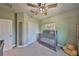 Bright Bedroom features soft green walls, carpet, and a grey wooden baby crib at 6338 Springline Pl, Apollo Beach, FL 33572