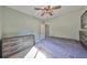 Bedroom features a decorative ceiling fan, hardwood floors, and a large chest of drawers at 6338 Springline Pl, Apollo Beach, FL 33572