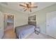Bedroom features a decorative ceiling fan, hardwood floors and a large painting on the wall at 6338 Springline Pl, Apollo Beach, FL 33572