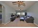 Inviting bonus room featuring a large couch, ceiling fans, and a functional layout at 6338 Springline Pl, Apollo Beach, FL 33572