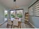 Charming dining area featuring modern lighting, neutral walls, and outdoor views through a large window at 6338 Springline Pl, Apollo Beach, FL 33572
