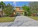 Charming two-story home featuring a well-maintained lawn and a spacious two-car garage at 6338 Springline Pl, Apollo Beach, FL 33572