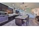 Modern kitchen featuring stainless steel appliances, dark cabinets, granite counters, and a spacious center island at 6338 Springline Pl, Apollo Beach, FL 33572