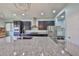Modern kitchen featuring stainless steel appliances, dark cabinets, granite counters, and a spacious center island at 6338 Springline Pl, Apollo Beach, FL 33572