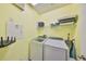 Well-lit laundry room features modern appliances, overhead lighting, and ample storage at 6338 Springline Pl, Apollo Beach, FL 33572