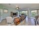 Inviting living room with tile flooring, modern ceiling fan, and sliding glass doors leading to the backyard at 6338 Springline Pl, Apollo Beach, FL 33572