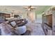 Bright living room with a plush rug, comfortable seating, and adjacent kitchen area at 6338 Springline Pl, Apollo Beach, FL 33572