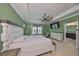 Stylish main bedroom with tray ceilings, a ceiling fan, and an en-suite bathroom at 6338 Springline Pl, Apollo Beach, FL 33572