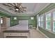 Bright main bedroom with a ceiling fan, neutral carpet, and two windows at 6338 Springline Pl, Apollo Beach, FL 33572