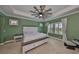 Spacious main bedroom featuring a ceiling fan, ample light, and neutral carpet at 6338 Springline Pl, Apollo Beach, FL 33572