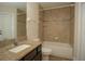 Bathroom with tub and shower combination, modern toilet, and granite vanity at 6527 Grapewood Rd, Spring Hill, FL 34609