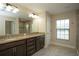 Bathroom featuring granite double vanity, marble tile flooring, and access to the glass-enclosed shower at 6527 Grapewood Rd, Spring Hill, FL 34609