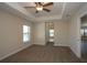 Spacious bedroom with neutral carpeting, ceiling fan, and natural light from the window at 6527 Grapewood Rd, Spring Hill, FL 34609