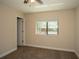 Bedroom featuring a window overlooking backyard, carpeted floors and neutral paint at 6527 Grapewood Rd, Spring Hill, FL 34609