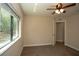 Bedroom features carpet flooring, neutral paint, and a large window offering bright natural light at 6527 Grapewood Rd, Spring Hill, FL 34609