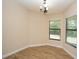 Cozy dining area with wood floors, a chandelier, and natural light from the windows at 6527 Grapewood Rd, Spring Hill, FL 34609