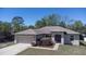 Charming single-story home featuring an attached two-car garage and well-maintained landscaping at 6527 Grapewood Rd, Spring Hill, FL 34609