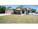 Inviting home with a well-maintained lawn, a two-car garage, and a welcoming entrance at 6527 Grapewood Rd, Spring Hill, FL 34609