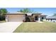 Charming single-story home with a well-manicured lawn and a spacious two-car garage at 6527 Grapewood Rd, Spring Hill, FL 34609