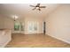 Cozy living room featuring wood floors, a ceiling fan, and ample natural light at 6527 Grapewood Rd, Spring Hill, FL 34609