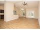 Spacious living room with wood floors and a view of the backyard through French doors at 6527 Grapewood Rd, Spring Hill, FL 34609