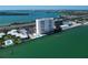 Elevated view showcases a waterfront condo building with a pool, parking, and beautiful bay vistas at 7200 Sunshine Skyway S Ln # 16G, St Petersburg, FL 33711