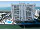 Aerial view of a waterfront condo community with a pool, lush landscaping, and ocean views at 7200 Sunshine Skyway S Ln # 16G, St Petersburg, FL 33711
