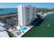 Tall white waterfront condo building featuring a pool, parking, and coastal access at 7200 Sunshine Skyway S Ln # 16G, St Petersburg, FL 33711