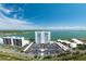 Waterfront condo complex featuring manicured lawns, a large parking area, and stunning bay views at 7200 Sunshine Skyway S Ln # 16G, St Petersburg, FL 33711