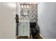 Powder room featuring gray geometric tile accent wall and black toilet at 7200 Sunshine Skyway S Ln # 16G, St Petersburg, FL 33711