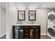 Modern bathroom featuring a dual sink vanity, sleek fixtures, and convenient in-unit washer and dryer at 7200 Sunshine Skyway S Ln # 16G, St Petersburg, FL 33711