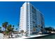Stunning exterior with a private pool, tiki huts, palm trees, and waterfront access at 7200 Sunshine Skyway S Ln # 16G, St Petersburg, FL 33711