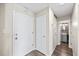 Hallway with vinyl floors leading to a bathroom with an elegant gray vanity at 7200 Sunshine Skyway S Ln # 16G, St Petersburg, FL 33711