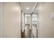 Bright hallway with wood floors leading to bedrooms and features mirrored closet doors at 7200 Sunshine Skyway S Ln # 16G, St Petersburg, FL 33711