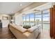 Bright living room with large windows showcasing stunning water views, modern furnishings and wood floors at 7200 Sunshine Skyway S Ln # 16G, St Petersburg, FL 33711