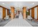 Grand lobby with tiled floors, wood accents, a chandelier, and seating areas for residents and guests at 7200 Sunshine Skyway S Ln # 16G, St Petersburg, FL 33711