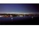 Captivating night view overlooking a tranquil bay dotted with sailboats and a distant cityscape illuminated at 7200 Sunshine Skyway S Ln # 16G, St Petersburg, FL 33711