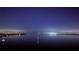 Scenic night view of the bay with boats anchored, showcasing the city lights across the calm water under a starry sky at 7200 Sunshine Skyway S Ln # 16G, St Petersburg, FL 33711