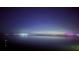 Night view showcasing water, distant city lights, and a star-filled sky creating a serene ambiance at 7200 Sunshine Skyway S Ln # 16G, St Petersburg, FL 33711