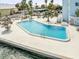 Inviting waterfront community pool surrounded by lounge chairs and lush tropical landscaping at 7200 Sunshine Skyway S Ln # 16G, St Petersburg, FL 33711