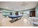 Spacious recreation room featuring ping pong tables, seating, and windows with natural light at 7200 Sunshine Skyway S Ln # 16G, St Petersburg, FL 33711