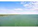 Scenic water view featuring a serene ocean, distant coastline, and picturesque sky with scattered clouds at 7200 Sunshine Skyway S Ln # 16G, St Petersburg, FL 33711